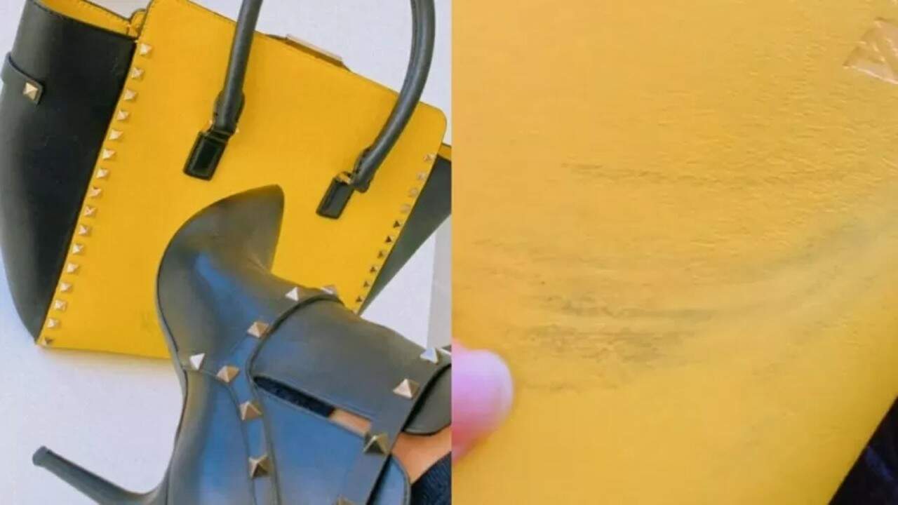 Foto mostra bolsa da Valentino com laterais e alça preta, e frente amarela, com marcas pretas de queimado na frente.