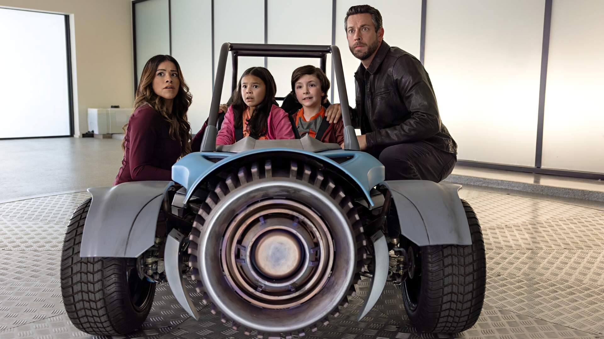 Gina Rodriguez as Nora Torrez, Everly Carganilla as Patty Torrez, Connor Esterson as Tony Torrez and Zachary Levi as Terrence Torrez in Spy Kids: Armageddon. Cr. Robert Rodriguez/Netflix